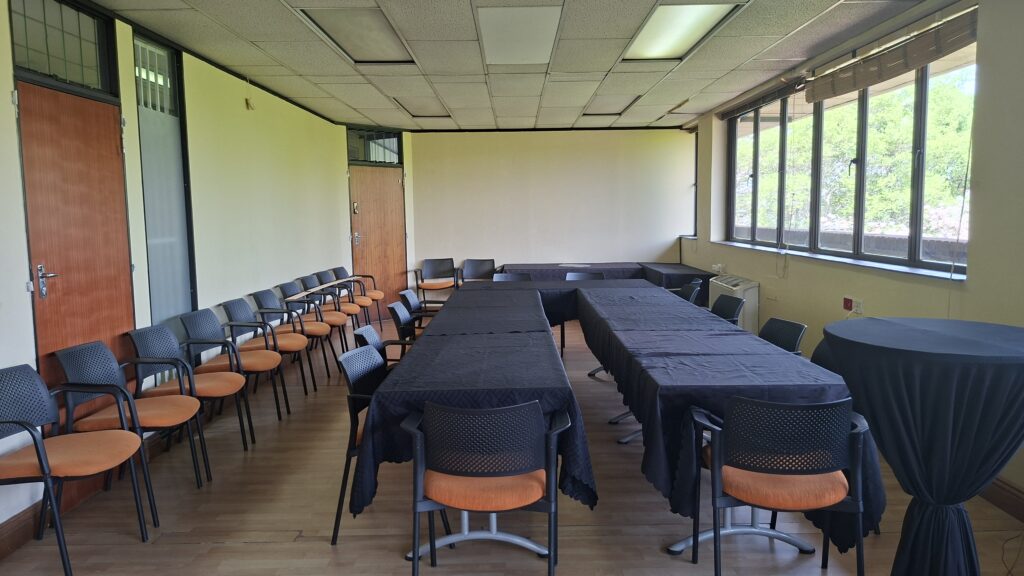Training room set up with rows of tables and chairs