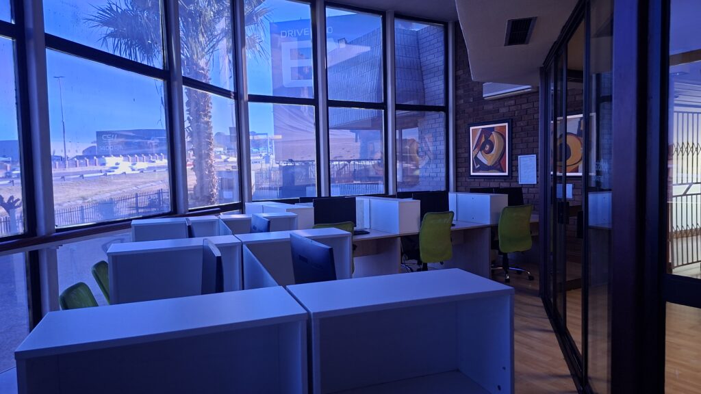 Open-plan workstations with large windows at the Softstart BTI work-space