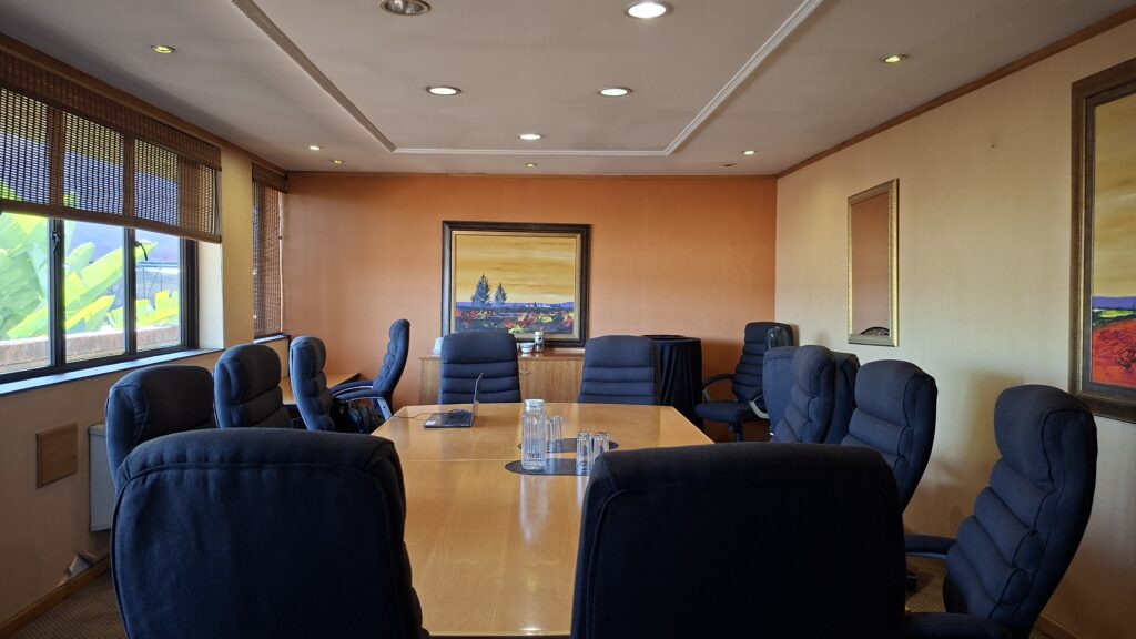Main boardroom with a long timber table and executive chairs