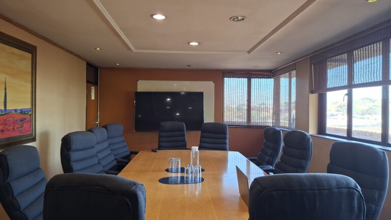 Boardroom with executive seating and a display screen