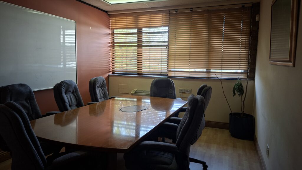 Meeting room with a polished table and office chairs