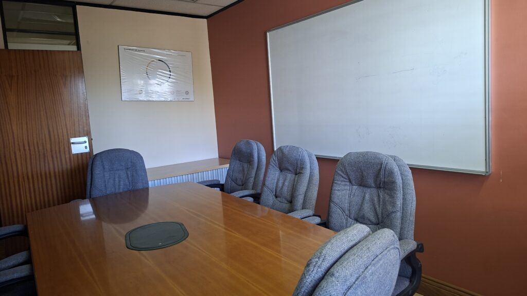 Small meeting room with whiteboard and seating
