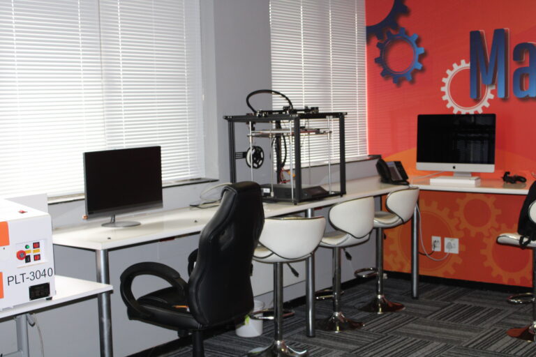 3D printer and computer workstation in the maker-space