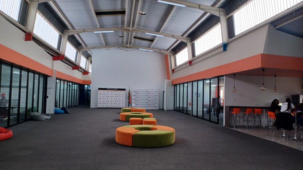 Bright foyer of the Botshabelo Digital Hub with orange seating