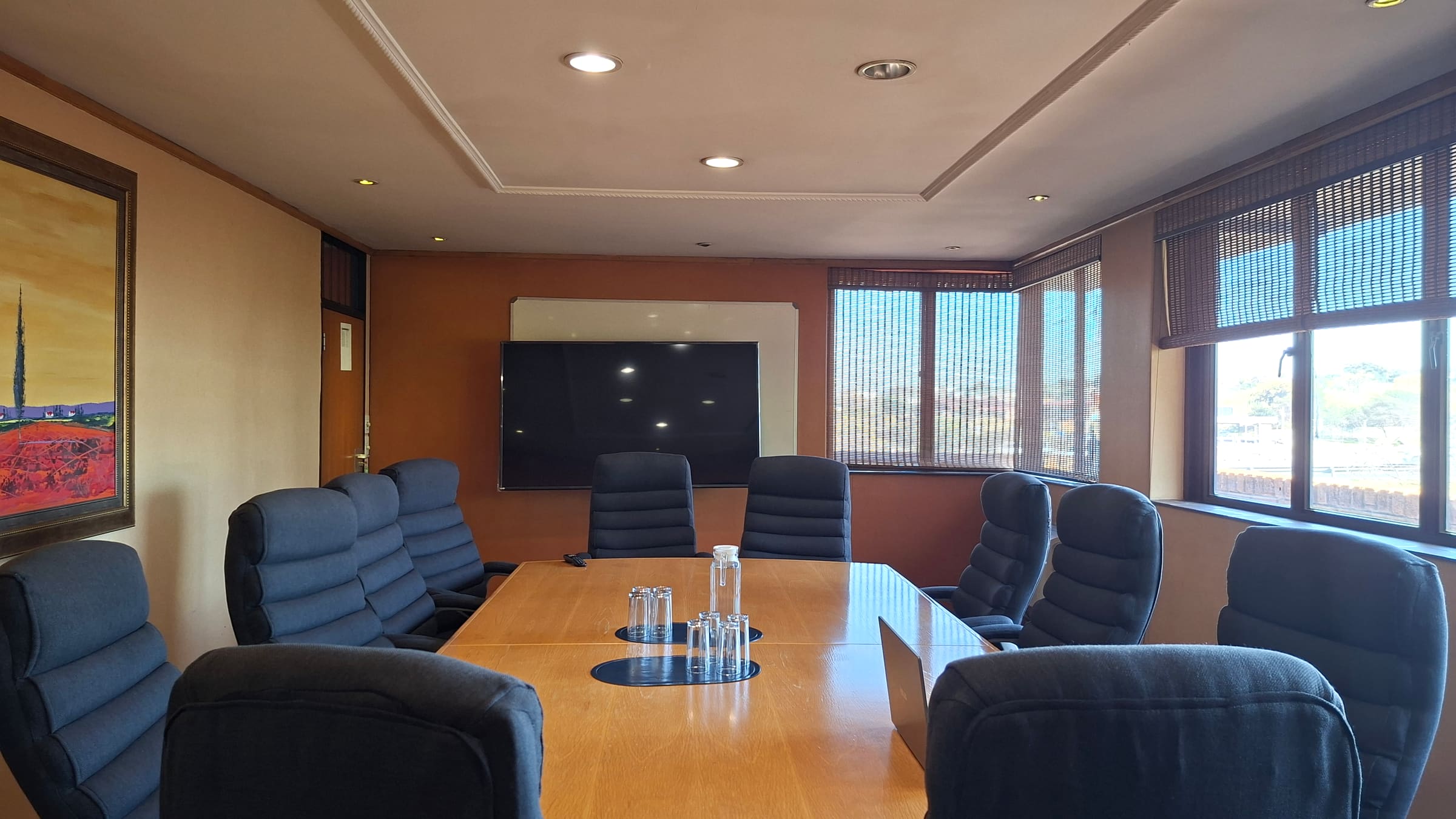 Softstart BTI main boardroom with a large table, leather chairs and a display screen
